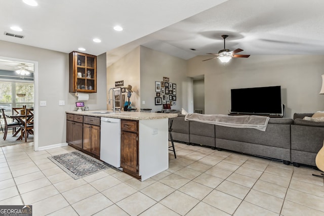 kitchen with visible vents, open floor plan, white dishwasher, a sink, and light tile patterned flooring