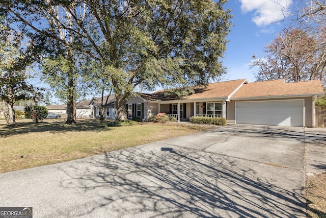 ranch-style house with a garage, concrete driveway, and a front lawn