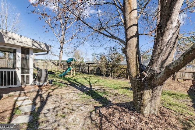 view of yard with a playground and a fenced backyard