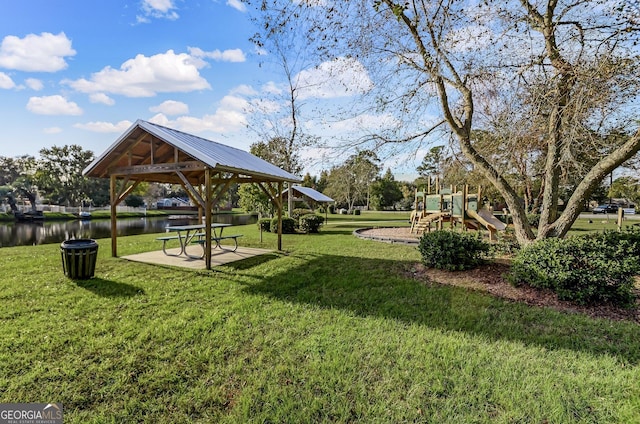 view of community featuring playground community, a yard, a gazebo, and a water view