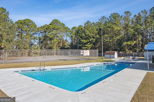 pool featuring a patio area and fence