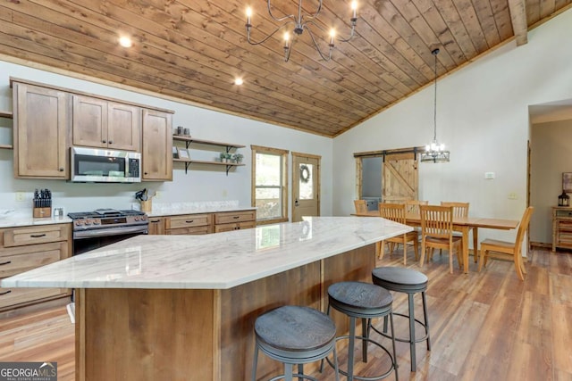 kitchen with a chandelier, stainless steel appliances, a barn door, open shelves, and wooden ceiling