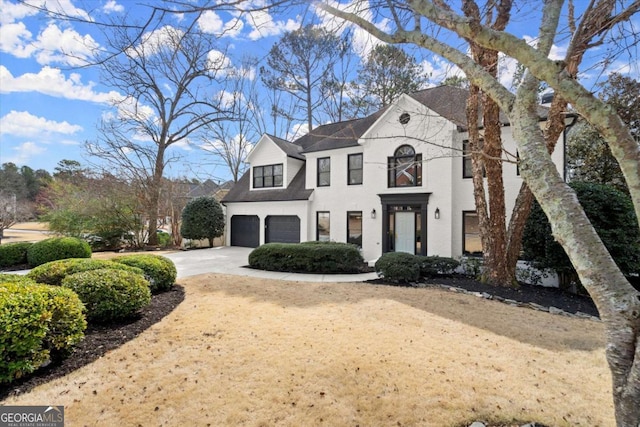 french provincial home featuring a garage and driveway