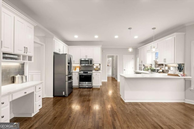 kitchen featuring a peninsula, appliances with stainless steel finishes, dark wood-type flooring, and white cabinets