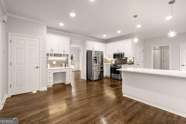 kitchen with dark wood-style flooring, stainless steel appliances, light countertops, decorative backsplash, and white cabinetry