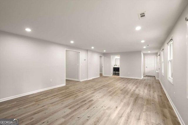 unfurnished living room with recessed lighting, baseboards, visible vents, and light wood finished floors