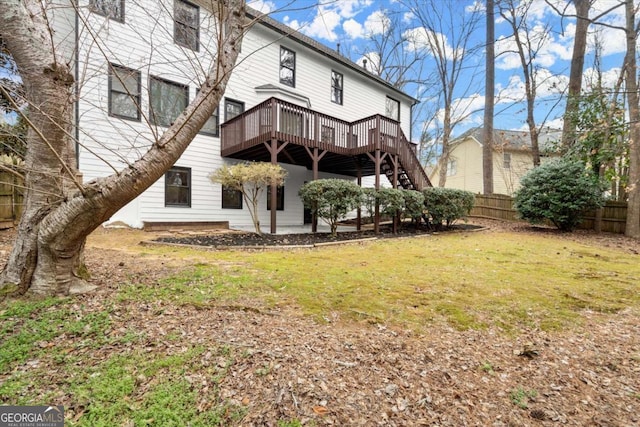 back of property featuring a yard, a patio, fence, a deck, and stairs