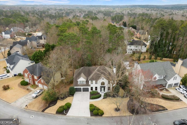 birds eye view of property featuring a residential view and a view of trees