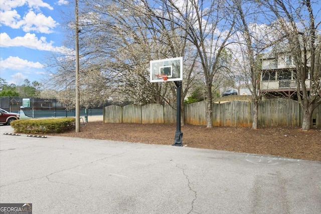 view of basketball court with community basketball court and fence