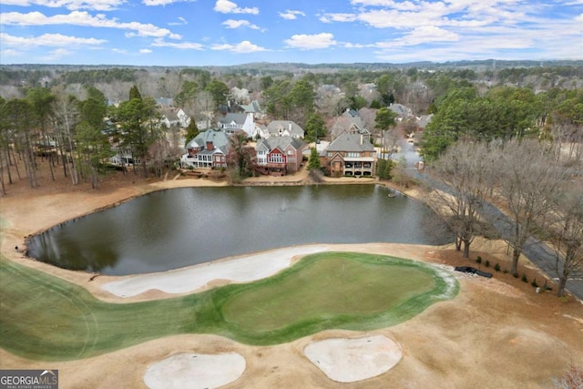 birds eye view of property featuring golf course view and a water view