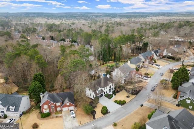 bird's eye view featuring a forest view and a residential view