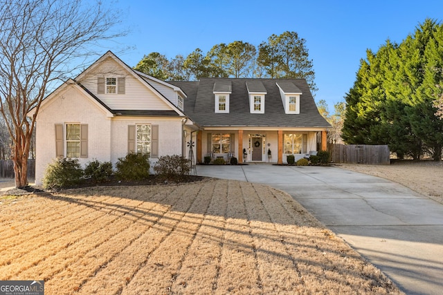 view of front of property featuring driveway and fence