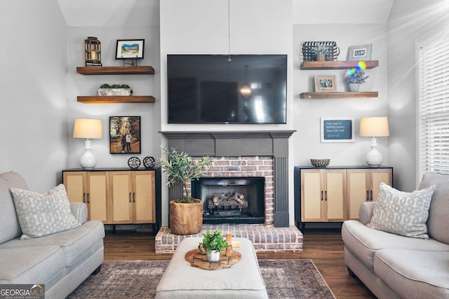 living room with a fireplace and dark wood finished floors