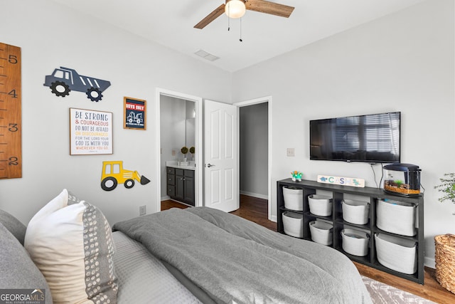 bedroom featuring baseboards, visible vents, a ceiling fan, connected bathroom, and wood finished floors