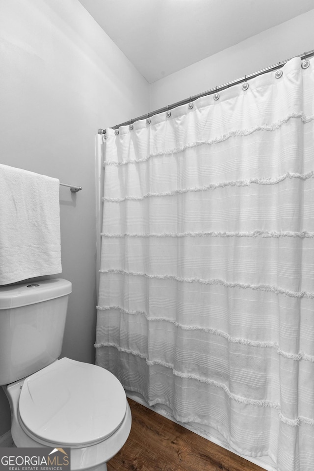 bathroom with toilet and wood finished floors