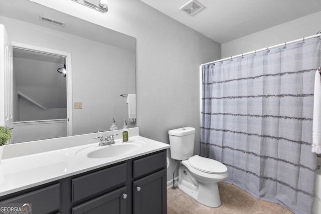 bathroom with visible vents, vanity, toilet, and tile patterned floors