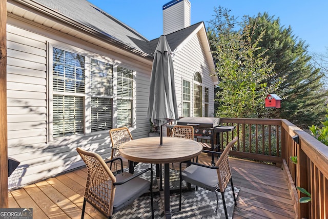 wooden deck with outdoor dining space