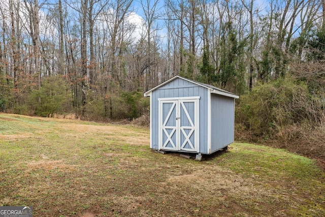 view of shed featuring a view of trees