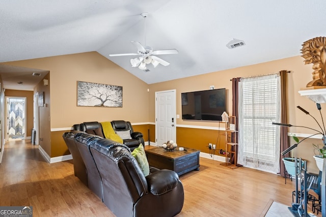 living area with visible vents, light wood-style flooring, a ceiling fan, vaulted ceiling, and baseboards