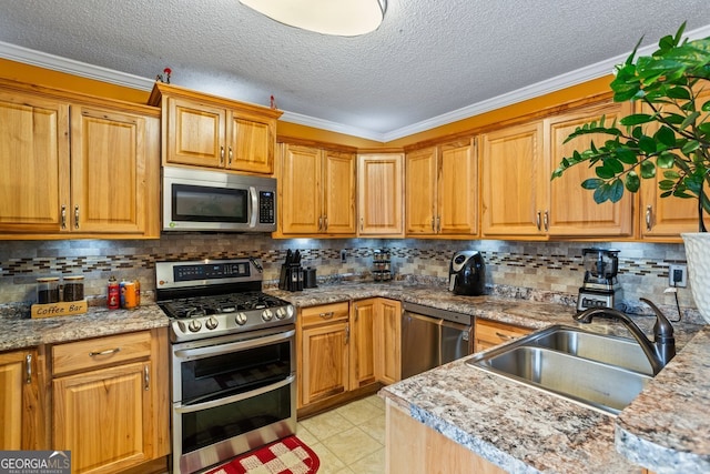 kitchen with light tile patterned floors, a sink, appliances with stainless steel finishes, backsplash, and crown molding