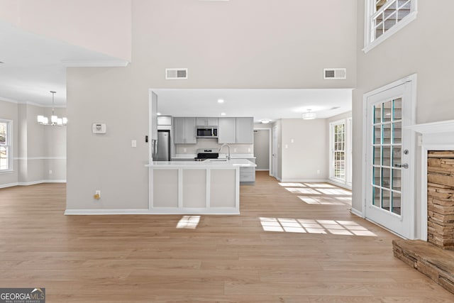 kitchen with a healthy amount of sunlight, visible vents, appliances with stainless steel finishes, and light countertops