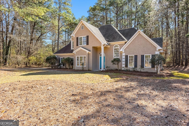 traditional-style home featuring stucco siding