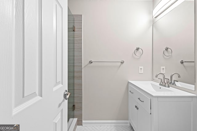 full bath with a shower, vanity, and baseboards