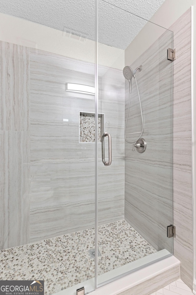 full bath featuring a shower stall