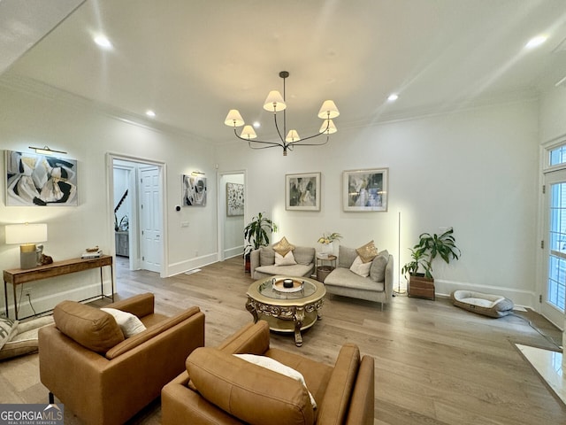 living area with ornamental molding, light wood-type flooring, a chandelier, and recessed lighting