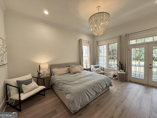 bedroom featuring ornamental molding, french doors, wood finished floors, and access to exterior