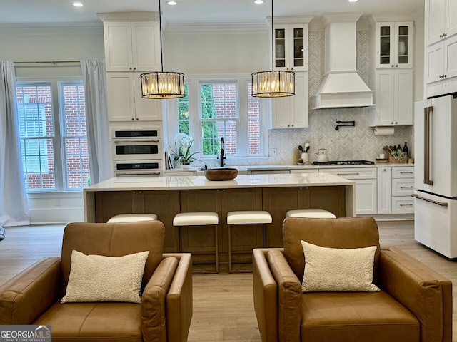 kitchen with open floor plan, white appliances, custom exhaust hood, and crown molding