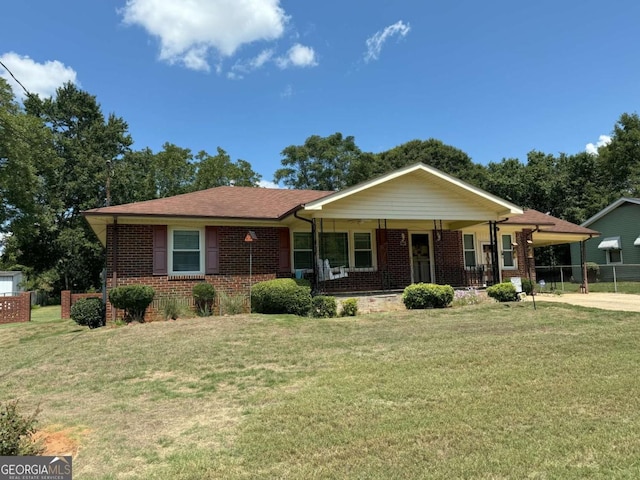 ranch-style house with brick siding, a front yard, and an attached carport