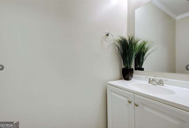 bathroom with vanity and ornamental molding