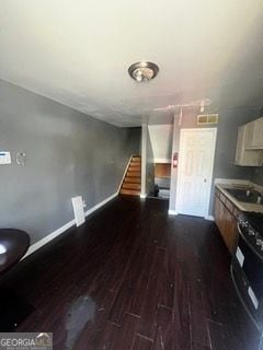 405 Fairburn Rd SW Unit 107, Atlanta, GA 30331 - unfurnished living room featuring dark wood-type flooring and stairs