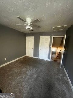 405 Fairburn Rd SW Unit 107, Atlanta, GA 30331 - unfurnished bedroom with attic access, carpet flooring, ceiling fan, and a textured ceiling