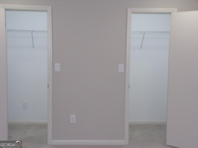 2401 Northlake Ct, Atlanta, GA 30345 - unfurnished bedroom featuring carpet flooring, baseboards, and multiple closets