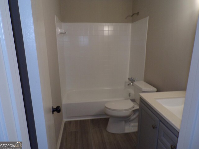 2401 Northlake Ct, Atlanta, GA 30345 - bathroom with washtub / shower combination, toilet, vanity, and wood finished floors