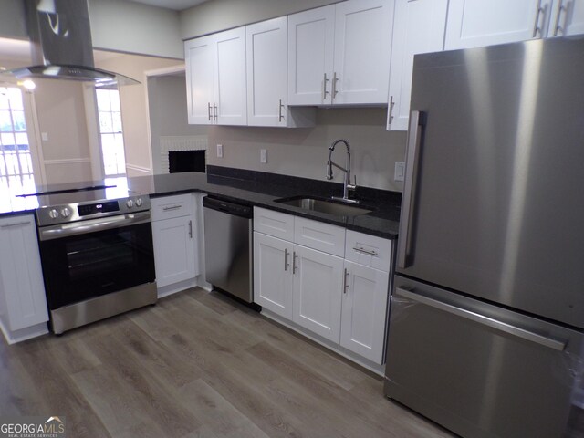 2401 Northlake Ct, Atlanta, GA 30345 - kitchen with a sink, wall chimney range hood, white cabinetry, and stainless steel appliances