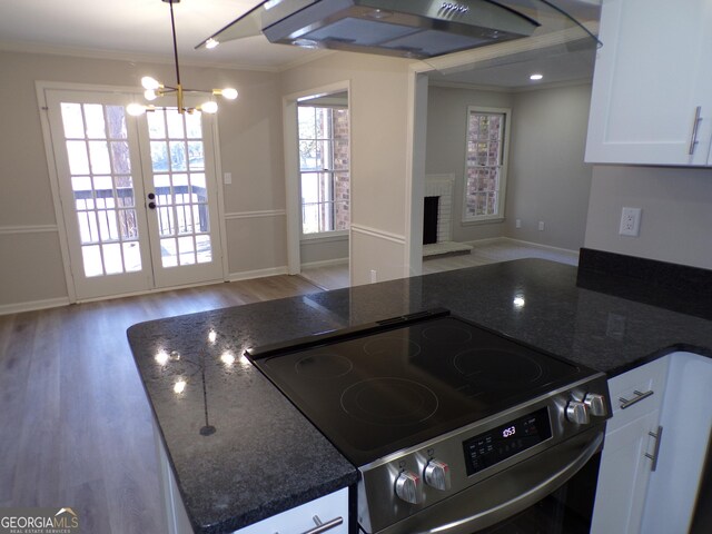 2401 Northlake Ct, Atlanta, GA 30345 - kitchen with open floor plan, ornamental molding, light wood-style flooring, stainless steel electric range, and exhaust hood