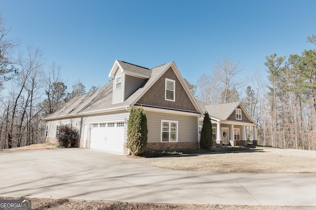 view of front facade with an attached garage, a porch, and concrete driveway