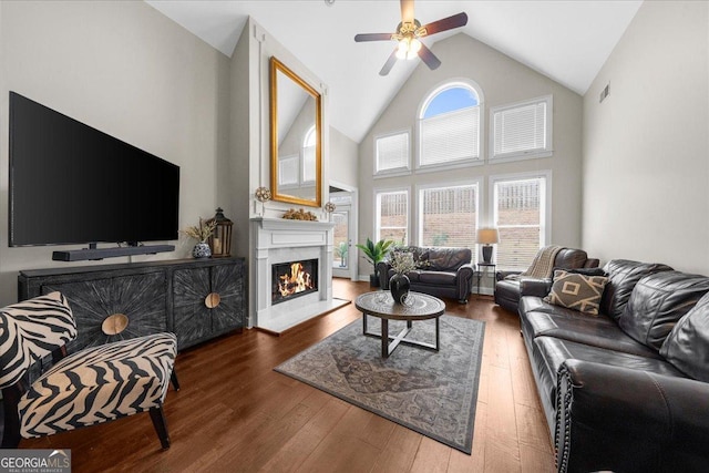 living area featuring a wealth of natural light, visible vents, and hardwood / wood-style floors