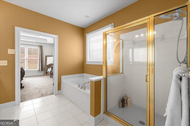 bathroom with a stall shower, tile patterned flooring, baseboards, and a bath