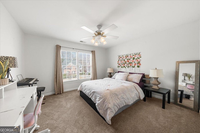 bedroom with light carpet, a ceiling fan, visible vents, and baseboards