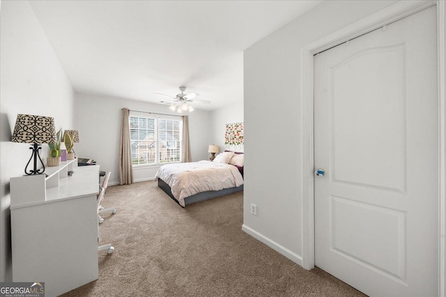 carpeted bedroom with a ceiling fan and baseboards