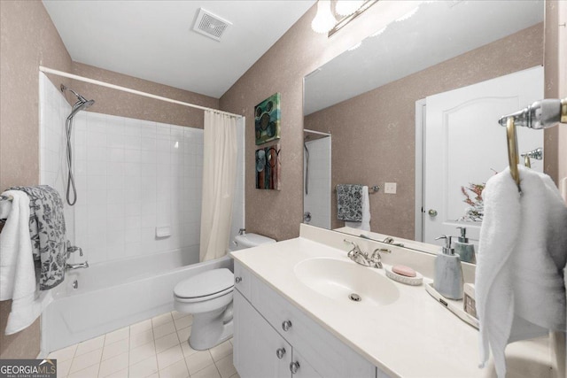 bathroom with visible vents, toilet, shower / bath combo with shower curtain, vanity, and tile patterned flooring