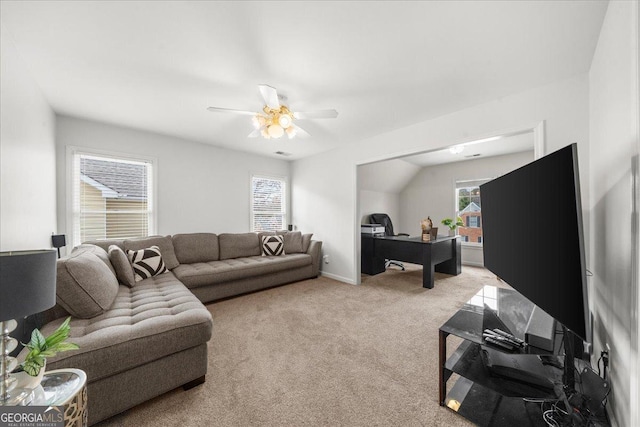 living room featuring a wealth of natural light, carpet flooring, and ceiling fan