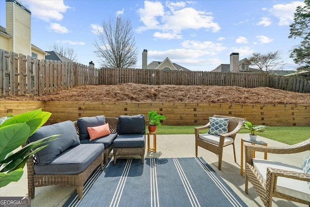 view of patio featuring outdoor lounge area and a fenced backyard