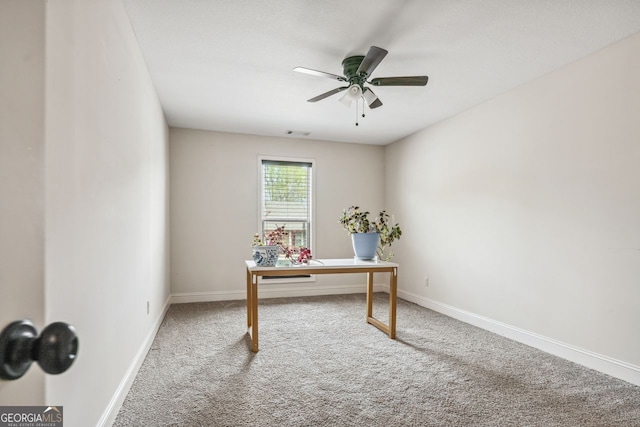 home office with baseboards, carpet floors, visible vents, and a ceiling fan