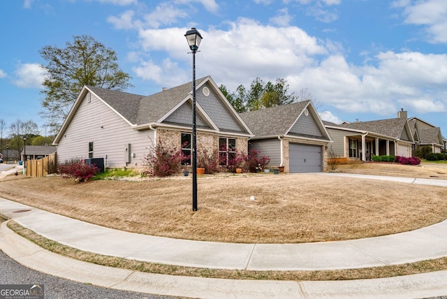 view of front of house featuring a front yard, central AC unit, driveway, a garage, and brick siding