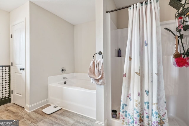 full bath with curtained shower, baseboards, a garden tub, and wood finished floors